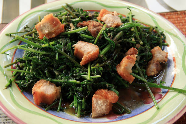 istock Stir-fried vegetable fern in oyster sauce with crispy Pork 676353512
