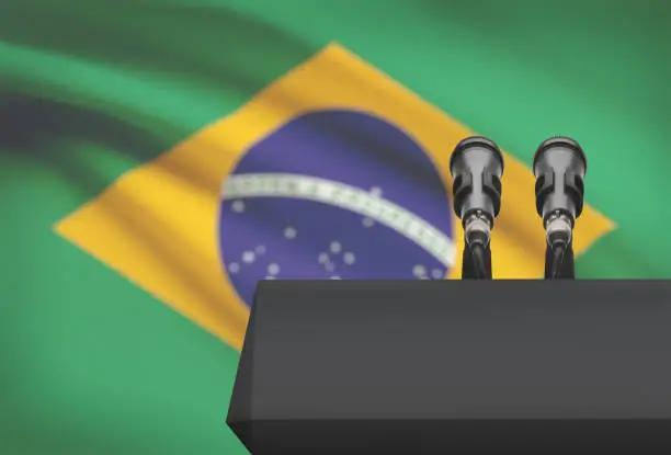 Pulpit and two microphones with a flag on background - Brazil