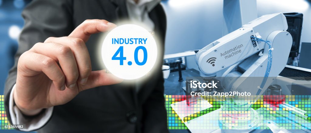 Industry 4.0 , Machine learning and artificial intelligence concept. Man suit hand holding Ai chipsets and blue tone of automate wireless Robot arm in smart factory background Arm Stock Photo