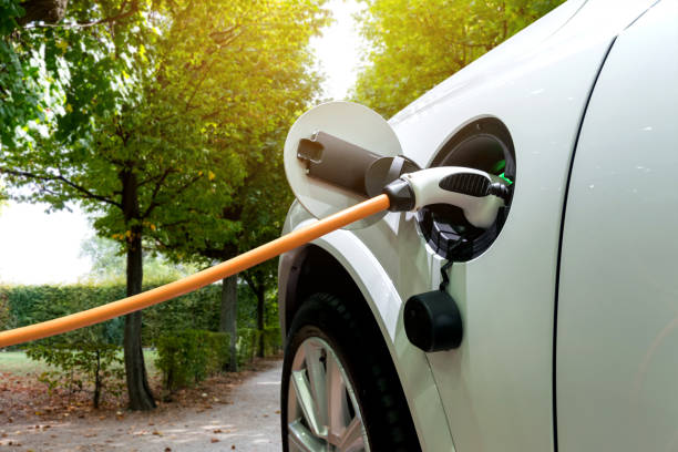 istock Charging an electric car with the power cable supply plugged in.Flare light effect 676364676