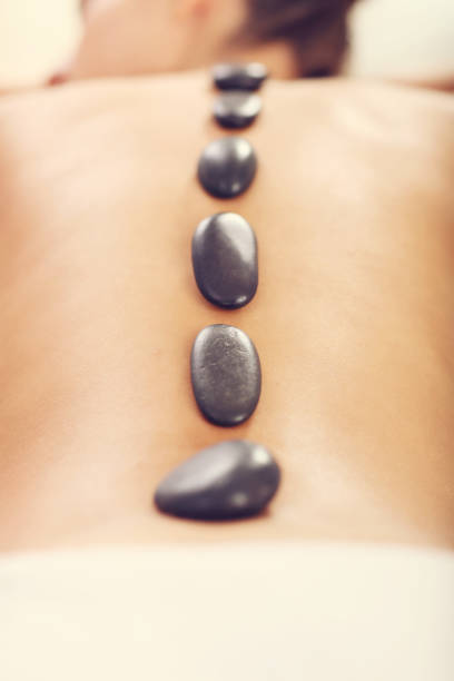 istock Beautiful woman getting stone massage in spa 676366972