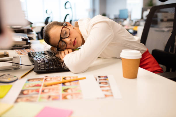 istock Tired businesswoman napping in creative office 676392680