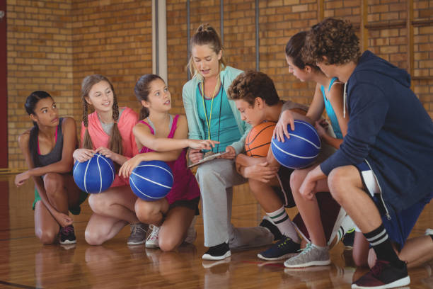 istock Female coach mentoring high school kids 676408174