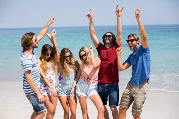 istock Young friends dancing at beach during sunny day 676408664