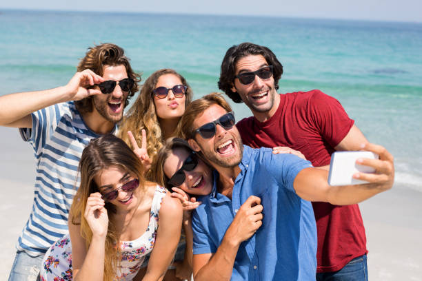 istock Young friends taking selfie at beach 676408772