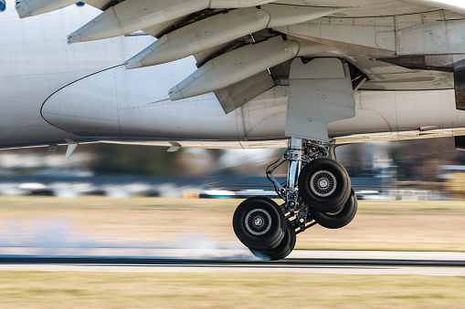 Main landing gear of big airplane during touchdown when wheel smoke