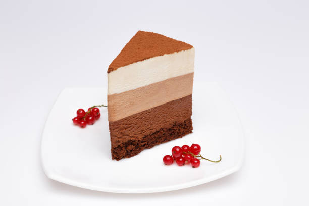 istock slice of the three chocolate mousse cake on a white plate 676411126