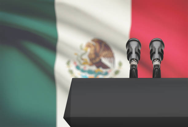Pulpit and two microphones with a national flag on background - Mexico stock photo