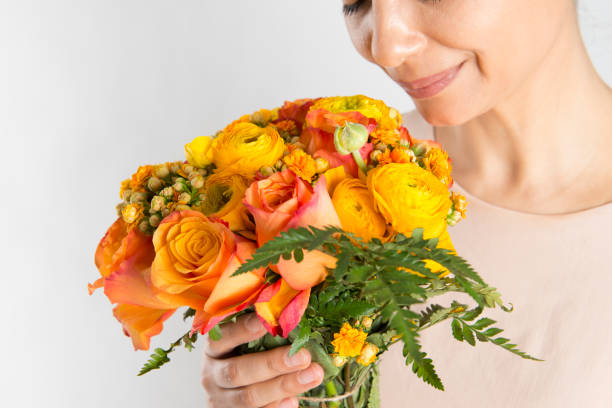 istock Woman Smelling Flowers 676460036