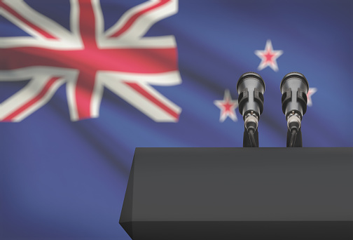 Pulpit and two microphones with a flag on background - New Zealand