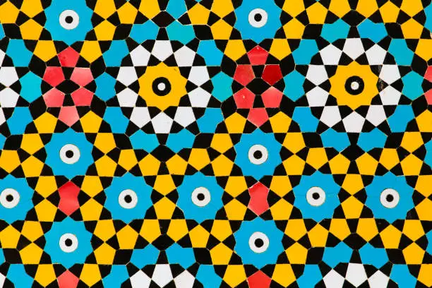 Colorful yellow and blue circles islamic decoration art mosaic on a mosque wall in Qom, Iran