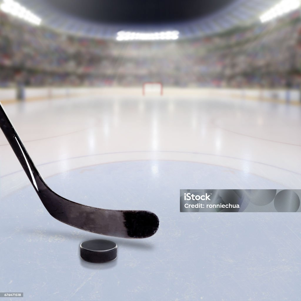 Hockey Stick and Puck on Ice of Crowded Arena Hockey stick and puck on ice in fictitious arena with fans in the stands and copy space. 3D rendering of hockey rink arena. Hockey Stick Stock Photo