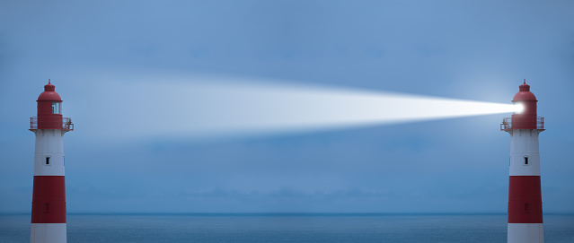 Being the bright one, lighthouses in action with beam, sea in background