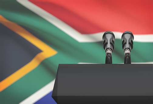 Pulpit and two microphones with a flag on background - South Africa