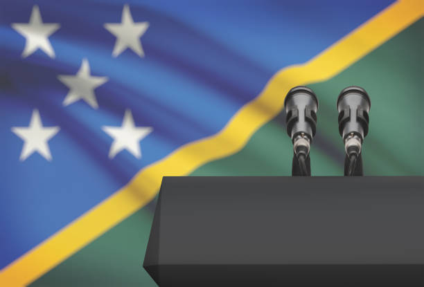 istock Pulpit and two microphones with a national flag on background - Solomon Islands 676499158