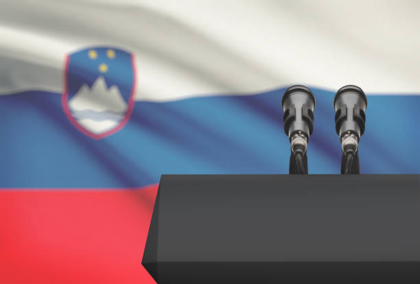 istock Pulpit and two microphones with a national flag on background - Slovenia 676499340