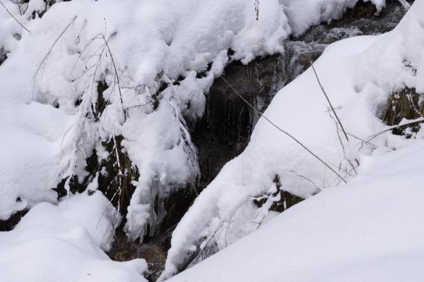 istock Water river stream covered by snow. Slovakia 676514622
