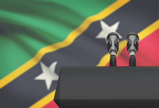 istock Pulpit and two microphones with a national flag on background - Saint Kitts and Nevis 676517402