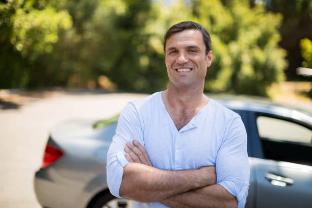 istock Man with arms crossed standing by car 676526808