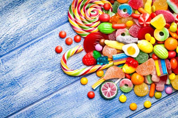 istock Colorful candies corner on blue table 676527562