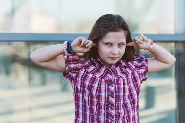 istock Girl covering her ears 676544298