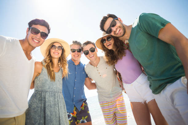 istock Young friends standing against sky 676569112