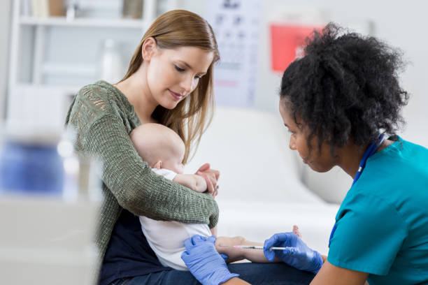 Pediatric nurse gives infant an immunization