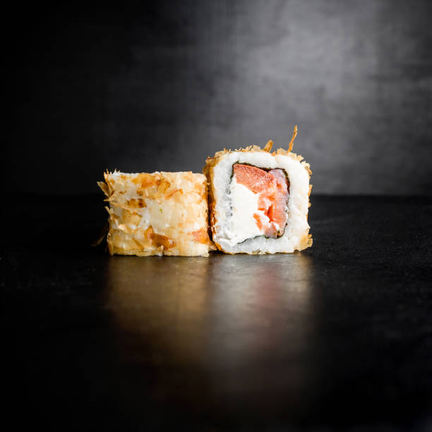 istock Sushi rolls on black background. Traditional food. 676571878