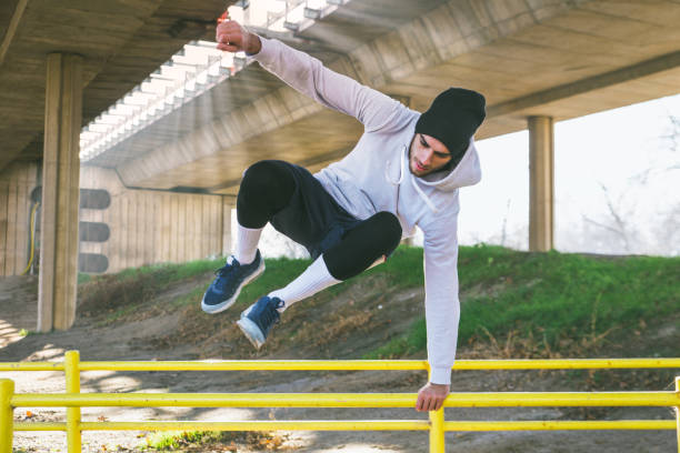 istock Young man training under the bridge, he jumping over the handrail. 676582154