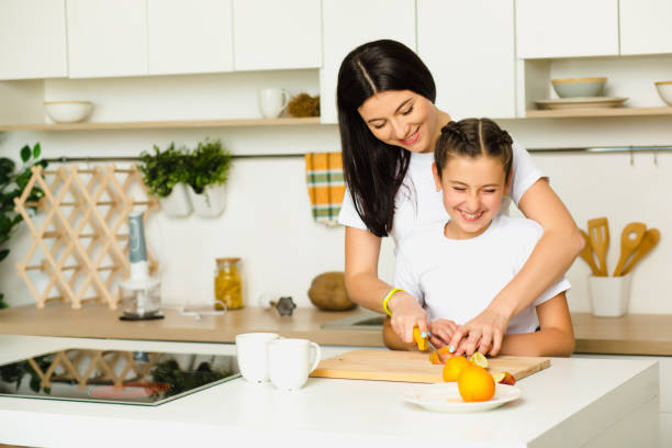 istock Happy mother and daughter cooking breakfast 676583162