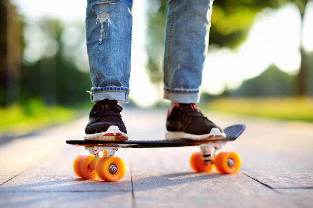 istock Hipster girl with skateboard outdoors. Closeup skateboarding 676596482