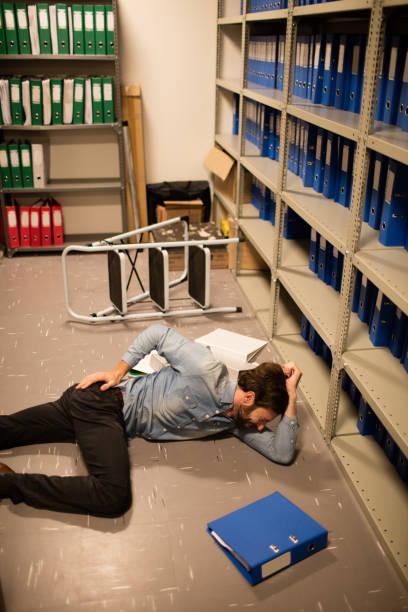 istock Fallen businessman with file in storage room 676606490