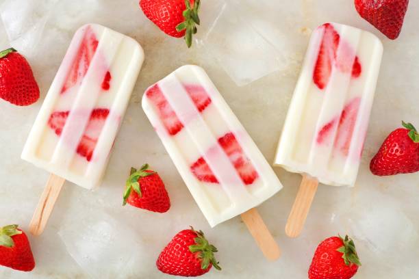 istock Healthy strawberry yogurt popsicles, overhead view on marble 676616296