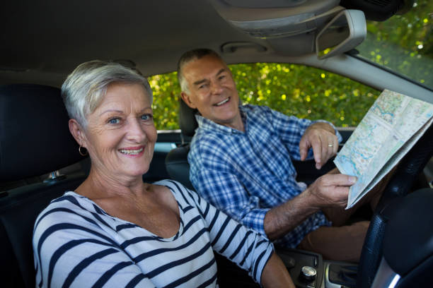 istock Senior couple with road map in car 676630916