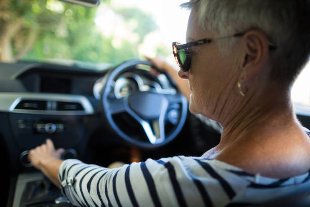 istock Serious senior woman driving car 676680596