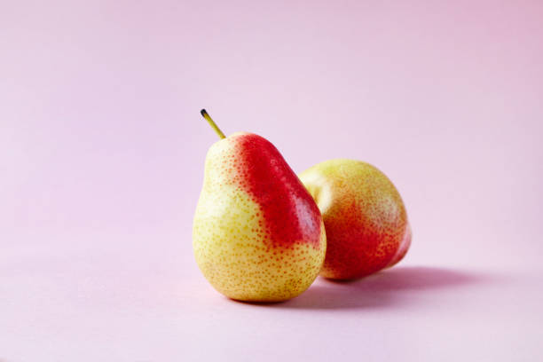 istock Fresh red pears on hipster pink background, modern style fruit and vegetable food, design layout 676680862