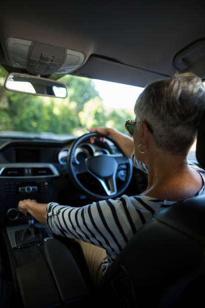 istock Senior woman driving car 676680966
