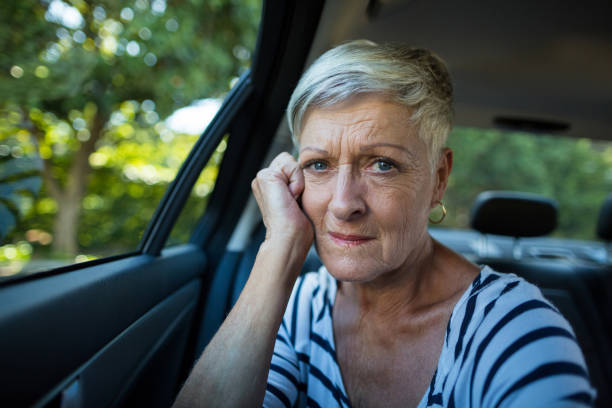 istock Tensed senior woman siting in car 676702896
