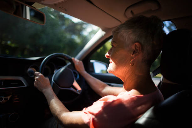 istock Senior woman driving car 676704240