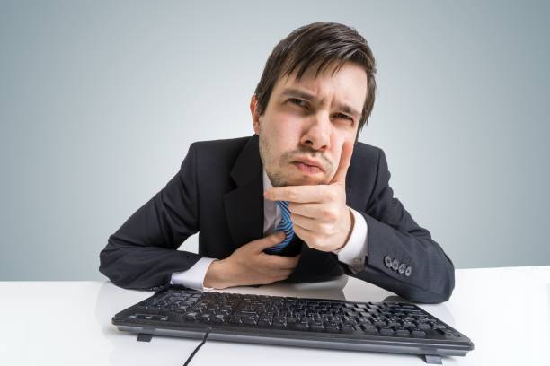 istock Suspicious businessman is looking at screen at work. 676716720