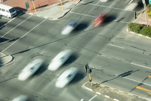 istock High angle view of blurred cars on road intersection 676726788
