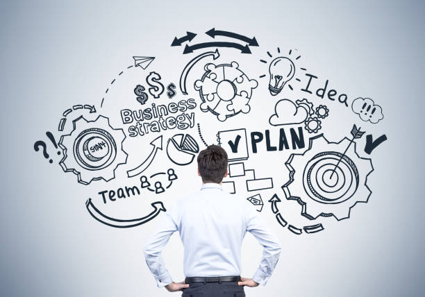 istock Man in blue looking at business plan 676736168