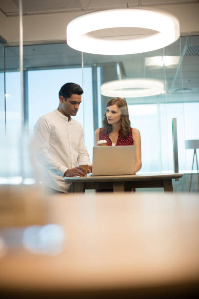 istock Business people discussing over laptop in office 676757098