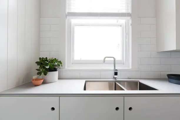 Photo of Close up details of contemporary white apartment kitchen