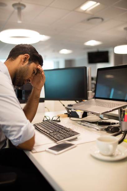 istock Tensed businessman sitting in office 676820888
