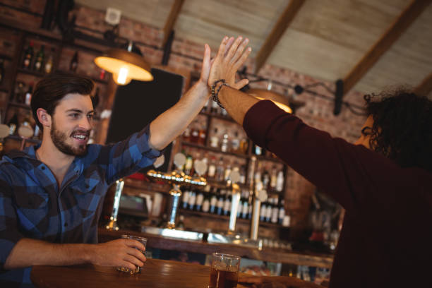 istock Two young men giving high five to each other 676847036
