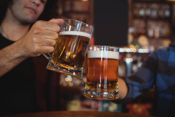 istock Two young men toasting their beer mugs 676850194