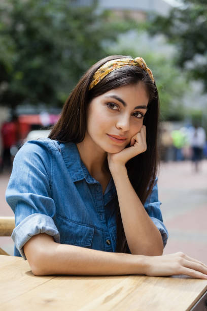 istock Thoughtful woman sitting at table in sidewalk cafe 676931914