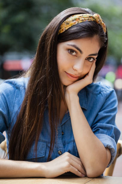 istock Beautiful thoughtful woman sitting at table in sidewalk cafe 676932104