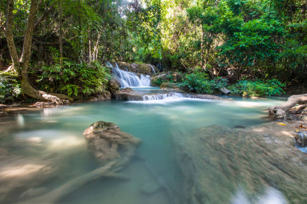 istock Waterfall in winter With bright green trees 676966494